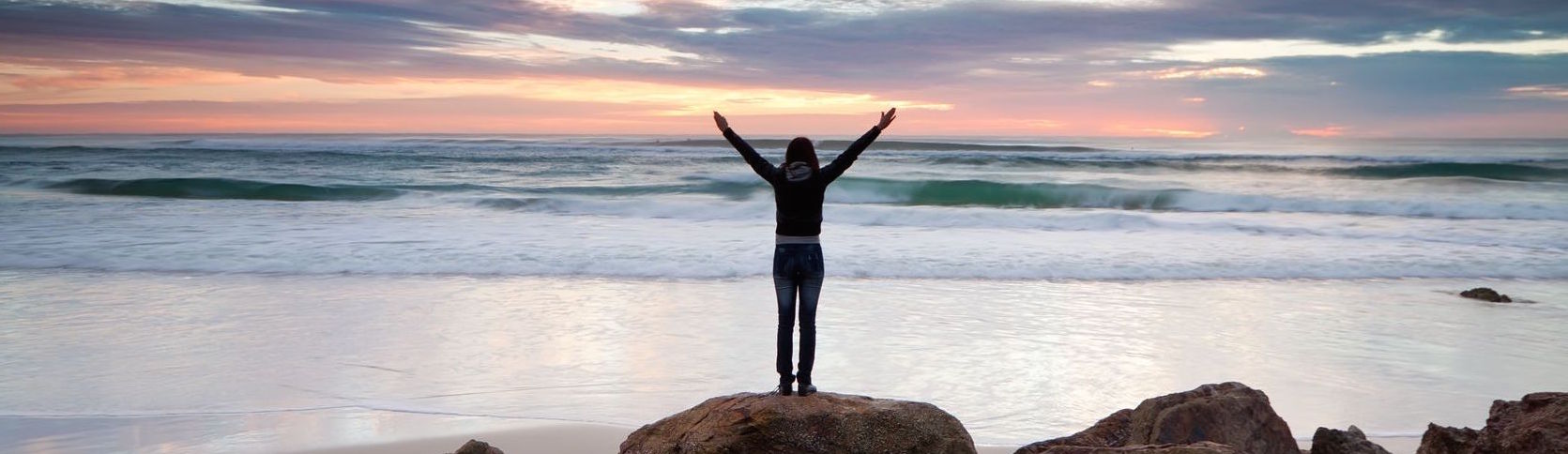 Header image; woman in-front of ocean.